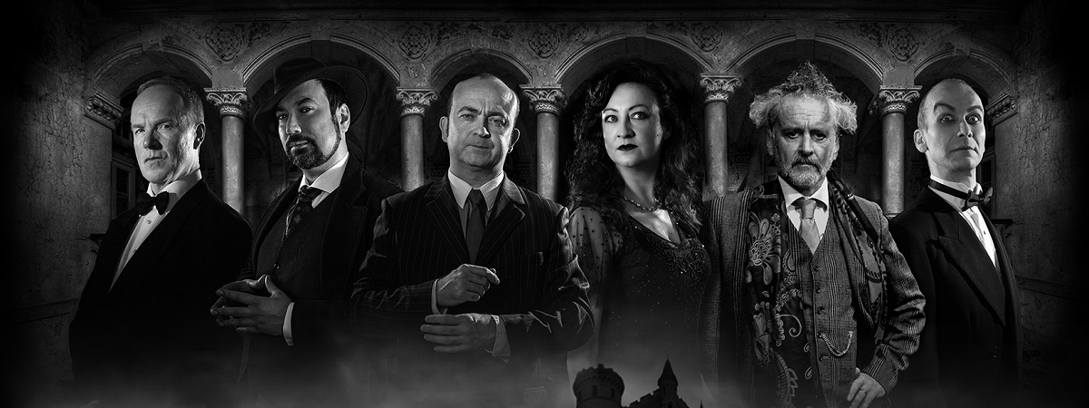 Six people stand in front of pillars in a promotional image for The Haunting of Blaine Manor.